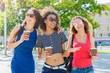 © Prostock-studio - Happy girls with take away coffee outdoors