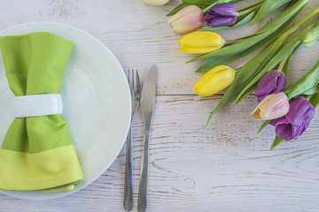 Wall Mural - Festive table setting with multicolored tulips