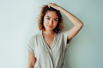 Wall Mural - Serious young woman touching or scratching head