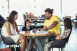 © Mediteraneo - Family with two children having great time in a cafe after shopping