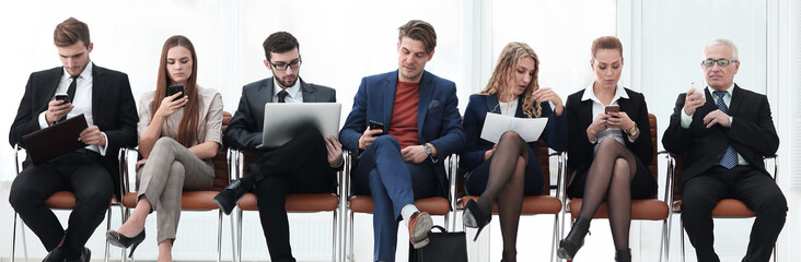 colleagues sitting in the conference room before the meeting