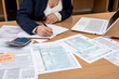 © RomanR - Woman filling US tax form