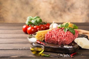 Wall Mural - Ingredients for spaghetti Bolognaise or Bolognese with savory minced beef and tomato, basil and spices. Italian healthy food concept with copy space.