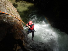 Canyoning - The Young Courageous Girl Abseiling Into The Canyon
