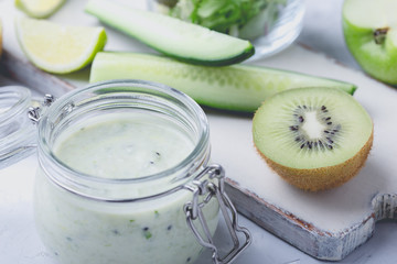 Poster - Healthy yoghurt beverage with fresh green leaf vegetables and fruits in glass jar