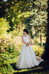  Beautiful blonde bride poses with orange wedding bouquet in the 