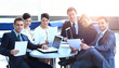 © ASDF - group of business people with documents sitting at a table in the lobby of the Bank.
