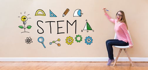 Wall Mural - STEM with young woman holding a pen in a chair