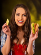 Woman eating piece of cheese and hamburger. Portrait of student consume fast food on table. Girl trying to eat junk. Advertise fast food on daek background. Expensive fast food restaurant.