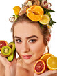 Hair mask from fresh fruits on woman head. Girl with beautiful face hold ingredient for homemade organic skin and hair therapy. Acceleration of hair and eyebrows growth.
