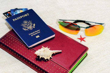 Red russian Passport with bank cards, glasses and seashells. The concept of travel.