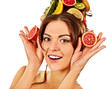 Hair and facial mask from fresh fruits for woman concept. Girl holds halves of grapefruit and avocado for homemade organic skin therapy on isolated. Improvement of skin condition.