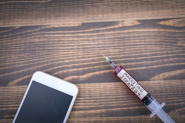 Wall Mural - marketing strategy concept. Medicine syringe with liquid inside and inscribtion.