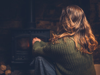 Wall Mural - Woman getting warm by the fire