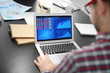 © Africa Studio - Young man with laptop working in office