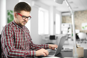 Sticker - Young man with laptop working in office