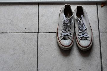 sneakers on the road. road. white sneakers on asphalt. Teenager's shoes stands on asphalt road