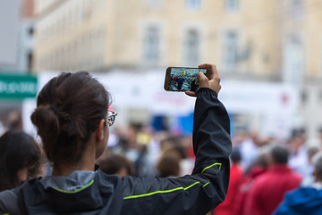 Taking Digital Photograph with Smartphone during Public City Marathon Sport Event