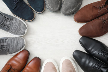 Wall Mural - Frame made of different male shoes on wooden background