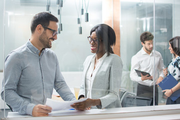 Wall Mural - Smiling business woman and man on meeting in office.