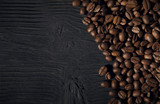 Fototapeta Kuchnia - coffee beans on a black old  wooden bg top view
