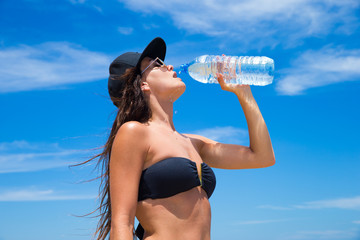  woman with water bottle in summer heat