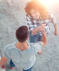 Wall Mural - young couple give each other five in new living room