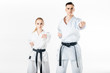 © LIGHTFIELD STUDIOS - Karate fighters standing in pose isolated on white
