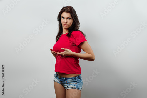 Fotografía Young, beautiful girl, stands holding her breasts with her hands