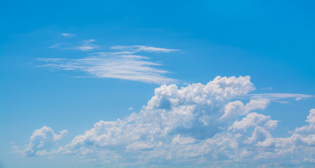 Wall Mural - white curly clouds in a blue sky. sky background