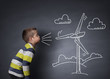 Child blowing a chalk wind turbine