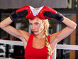 Sport boxing woman wearing red gloves. Girl is in corner of ring and is preparing for martial arts battle.