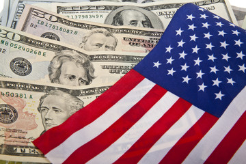 Wall Mural - dollars and the US flag as a background