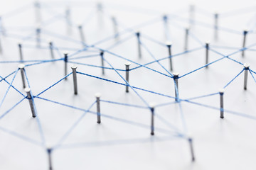 Sticker - A large grid of pins connected with string. Communication, technology, network concept