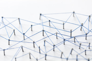 Poster - A large grid of pins connected with string. Communication, technology, network concept
