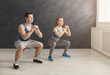 © Prostock-studio - Young couple in sportswear doing squat