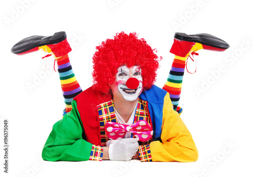Cuadros en Lienzo Happy clown isolated over white background laying on the floor