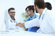 © ASDF - handshake between the two doctors during the working meeting