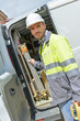 © auremar - builder taking tools out of his professional truck van