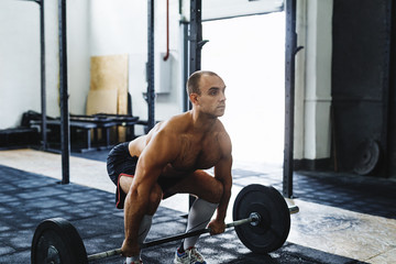 Shot of young bodybuilder working out at gym