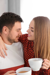 Poster - Cute young lovely couple drinking tea at home