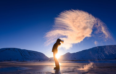 Wall Mural - boiling water frost in polar arctic sky in norway svalbard in longyearbyen man mountains