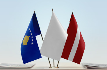 Flags of Kosovo and Latvia with a white flag in the middle