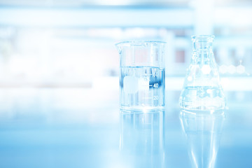 Wall Mural - clear blue beaker and flask and chemical structure in research science laboratory background