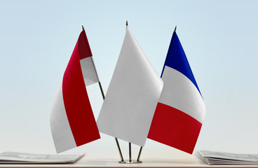 Flags of Monaco and France with a white flag in the middle