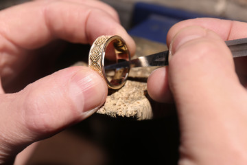 Jeweler working on golden ring, closeup