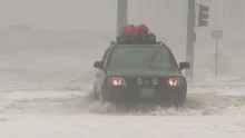A Car Drives Through Deep Water During Flooding From A Massive Storm Or Hurricane.