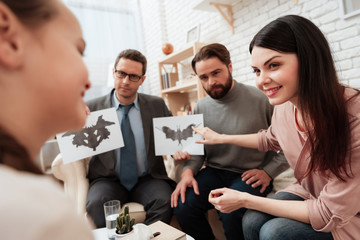 Wall Mural - Little girl pass Rorschach test together with her parents in office of psychologist.