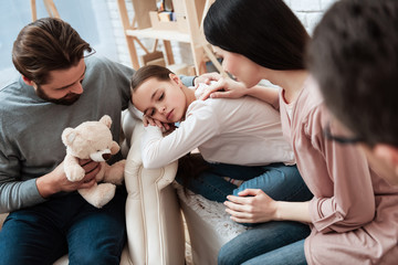 Wall Mural - Adult father tries to attract little girl's attention with help of teddy bear.