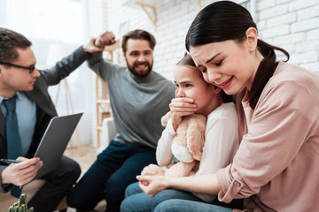 Wall Mural - Frightened woman with child is afraid of aggressive man who raised his hand.